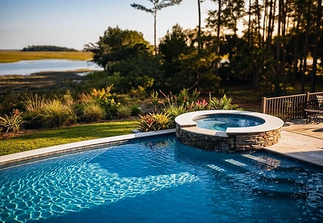 A finished pool and round spa on a cleared marsh-front lot